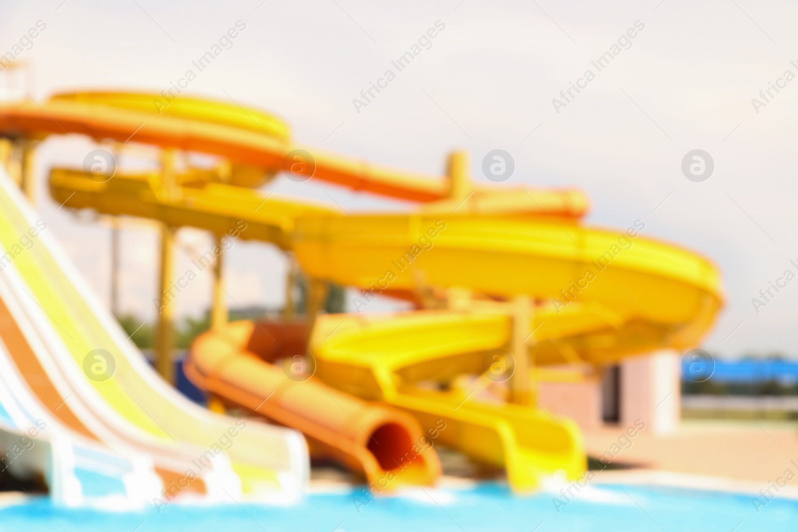 Photo of Different colorful slides in water park, blurred view