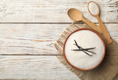 Photo of Flat lay composition with vanilla sugar on wooden background