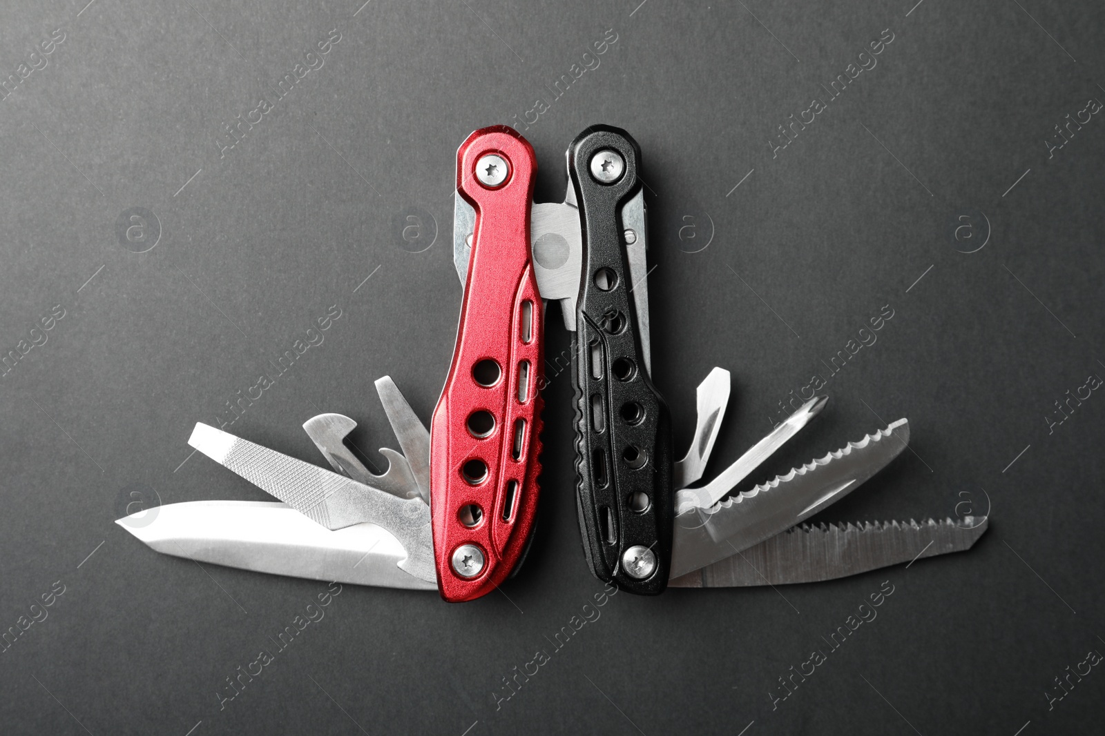 Photo of Compact portable multitool on grey background, top view