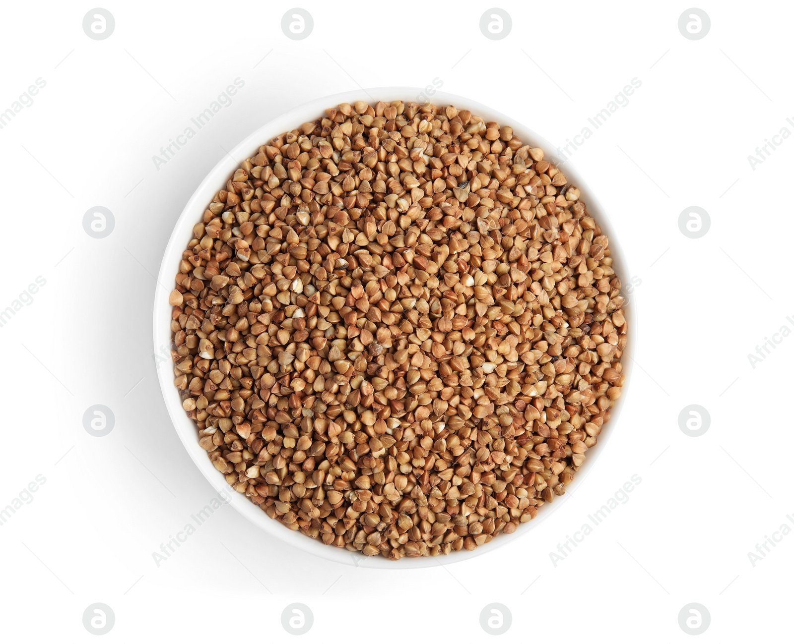 Photo of Bowl with uncooked buckwheat on white background, top view