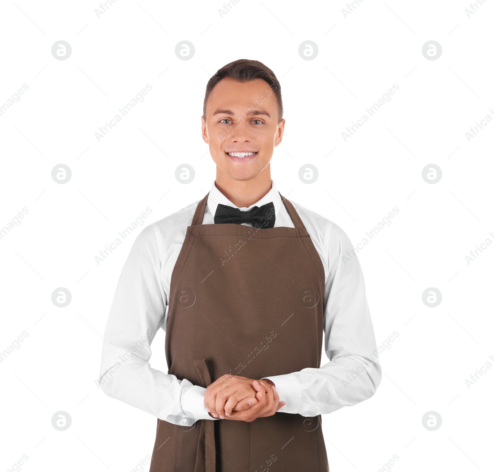 Photo of Portrait of young waiter in uniform on white background