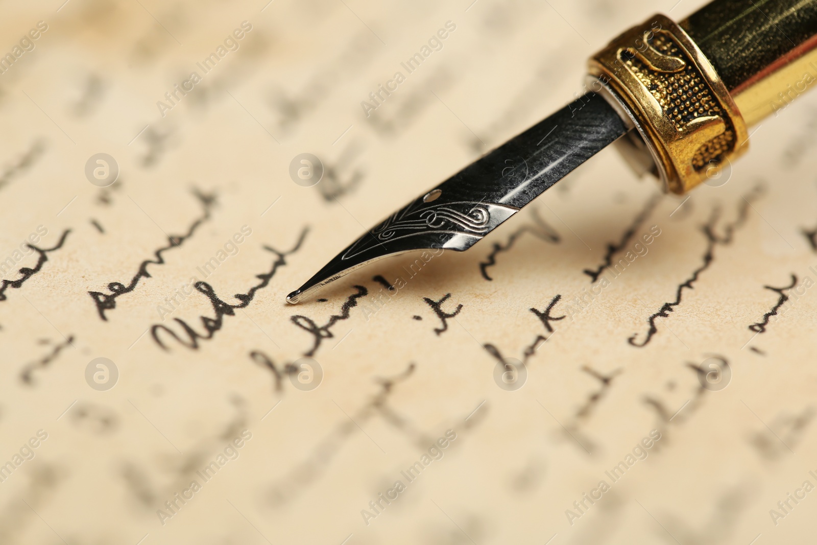 Photo of One fountain pen on handwritten letter, closeup