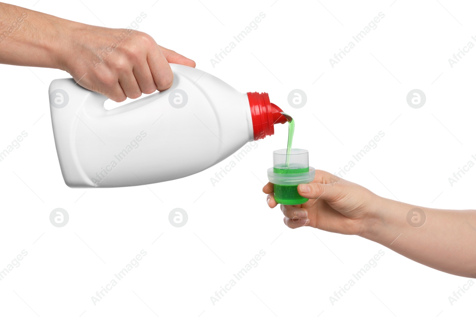 Photo of Man pouring fabric softener from bottle into cap for washing clothes on white background, closeup