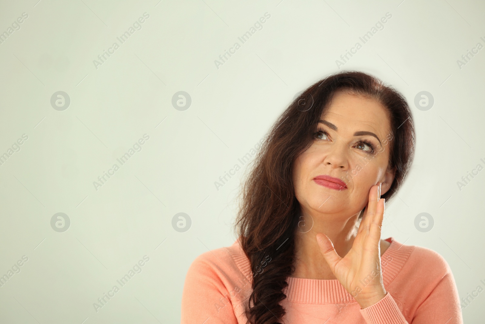 Photo of Portrait of beautiful older woman on light background with space for text