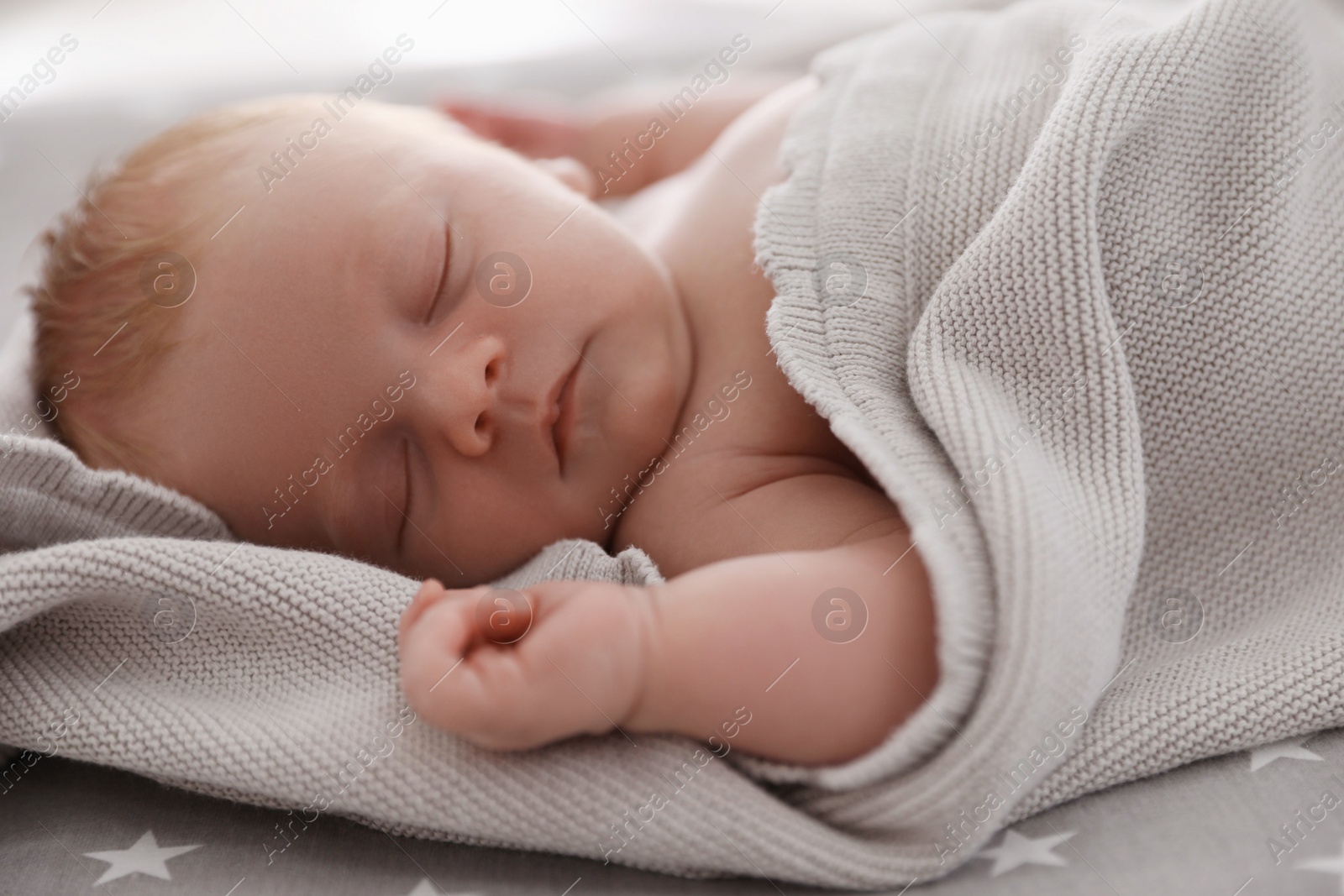 Photo of Cute little baby sleeping on bed, closeup