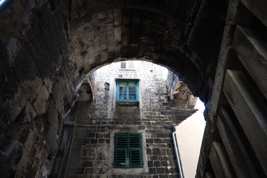 Old residential building, low angle view through arch entrance