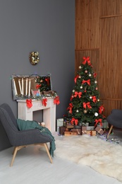 Photo of Stylish living room interior with decorated Christmas tree