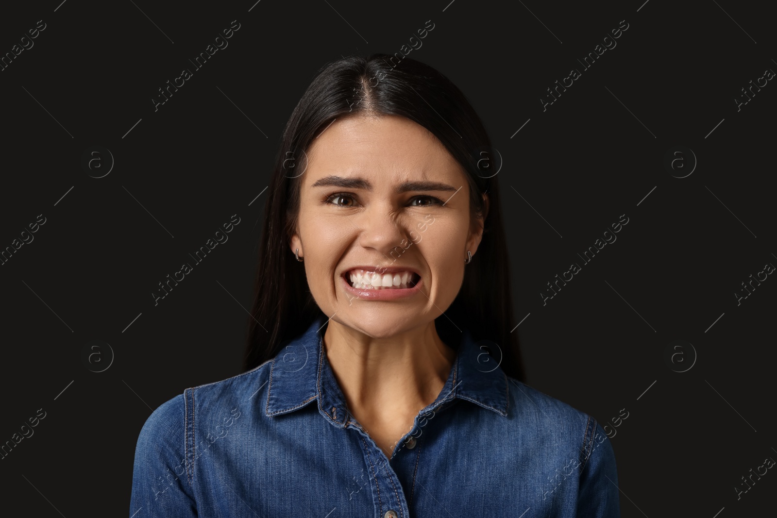 Photo of Personality concept. Emotional woman on black background