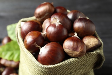 Fresh sweet edible chestnuts in sack, closeup