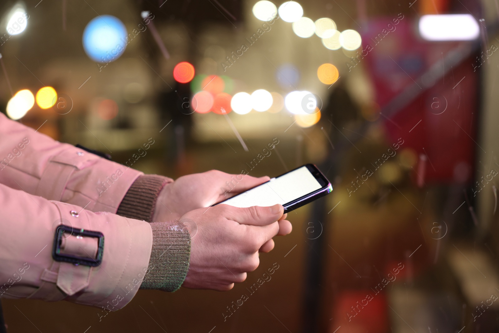 Photo of Man using smartphone on night city street, closeup. Space for text