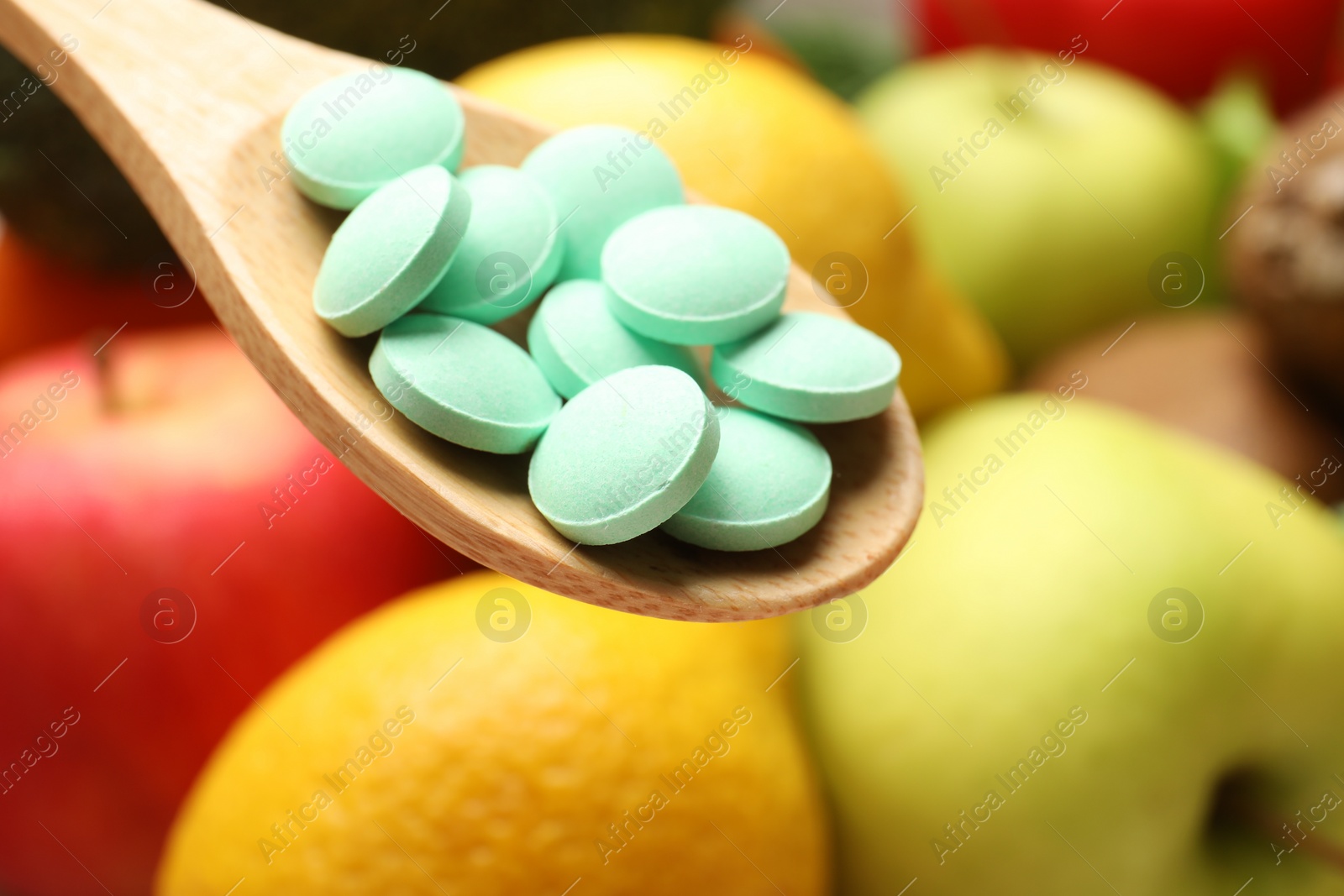 Photo of Dietary supplements. Spoon with pills over food products, closeup