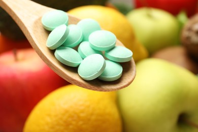 Dietary supplements. Spoon with pills over food products, closeup