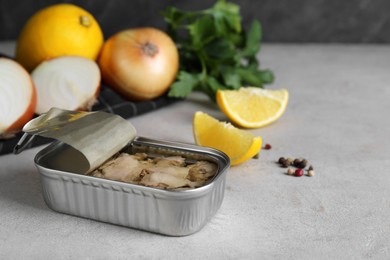 Photo of Open tin can of tasty cod liver on textured table, closeup. Space for text