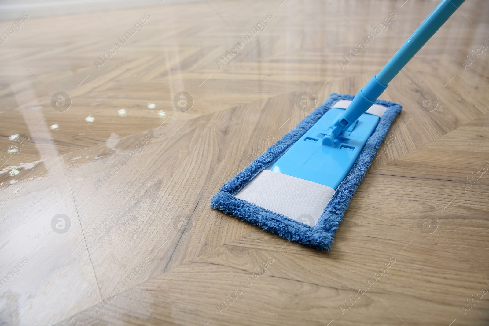 Photo of Washing of parquet floor with mop, closeup. Space for text