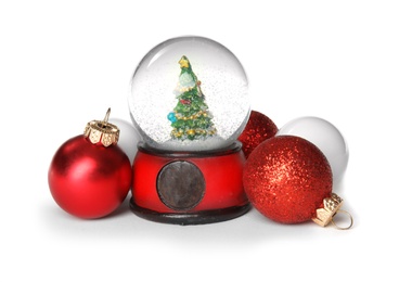 Photo of Magical snow globe with Christmas balls on white background