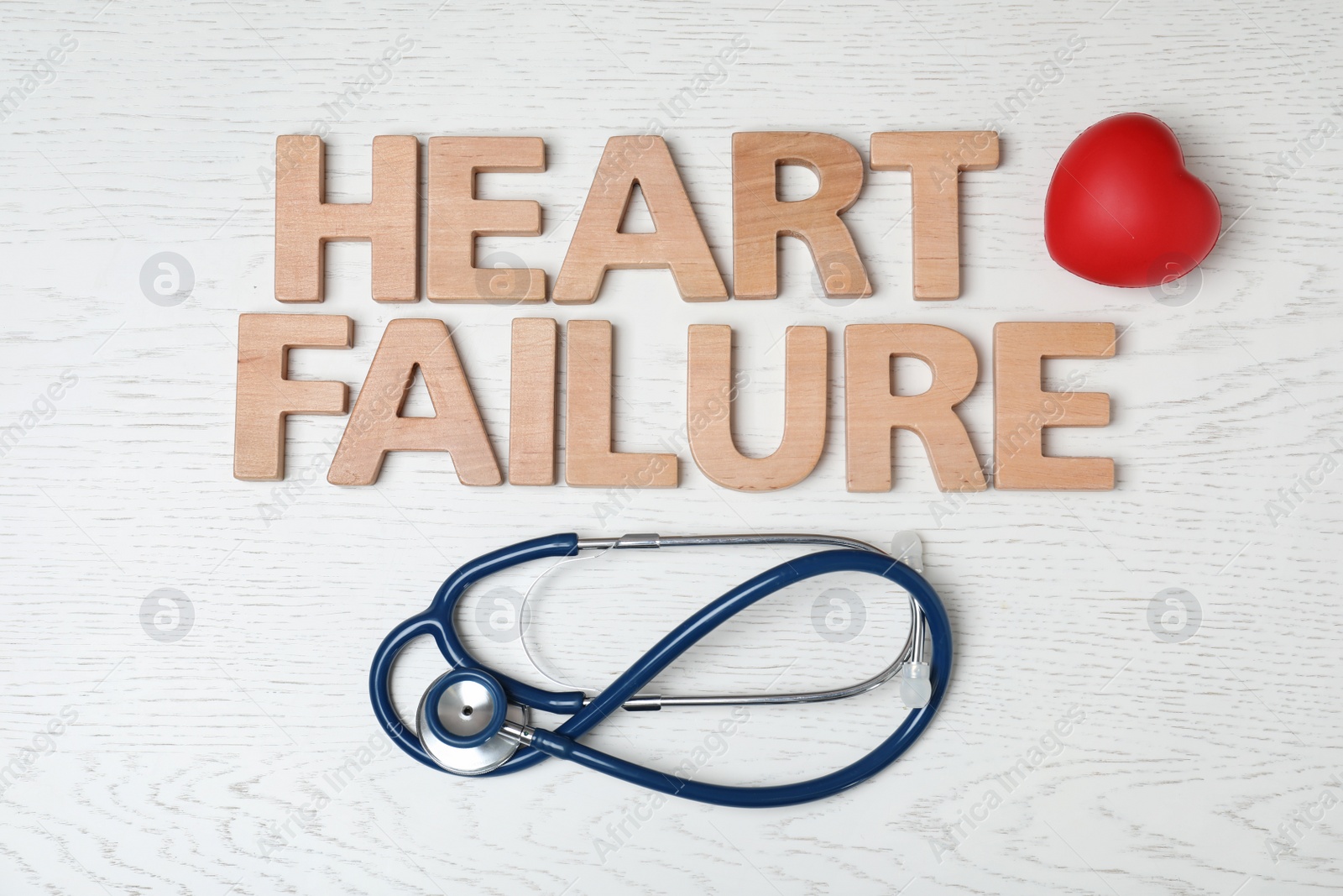 Photo of Text Heart Failure and stethoscope on light background, flat lay