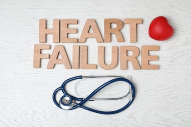 Text Heart Failure and stethoscope on light background, flat lay