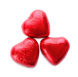 Photo of Heart shaped chocolate candies in red foil on white background, top view