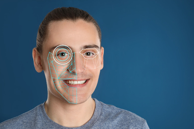 Facial recognition system. Man with digital biometric grid on blue background