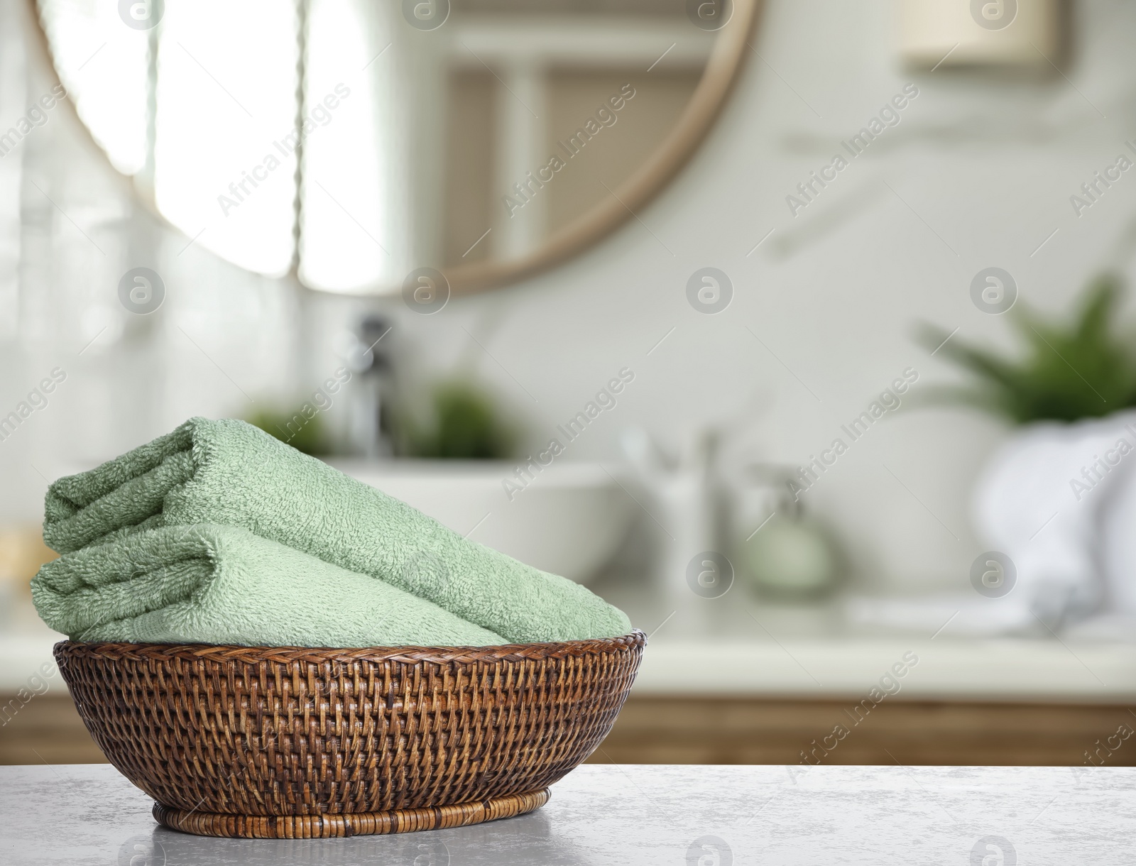 Image of Fresh towels on grey table in bathroom. Space for text