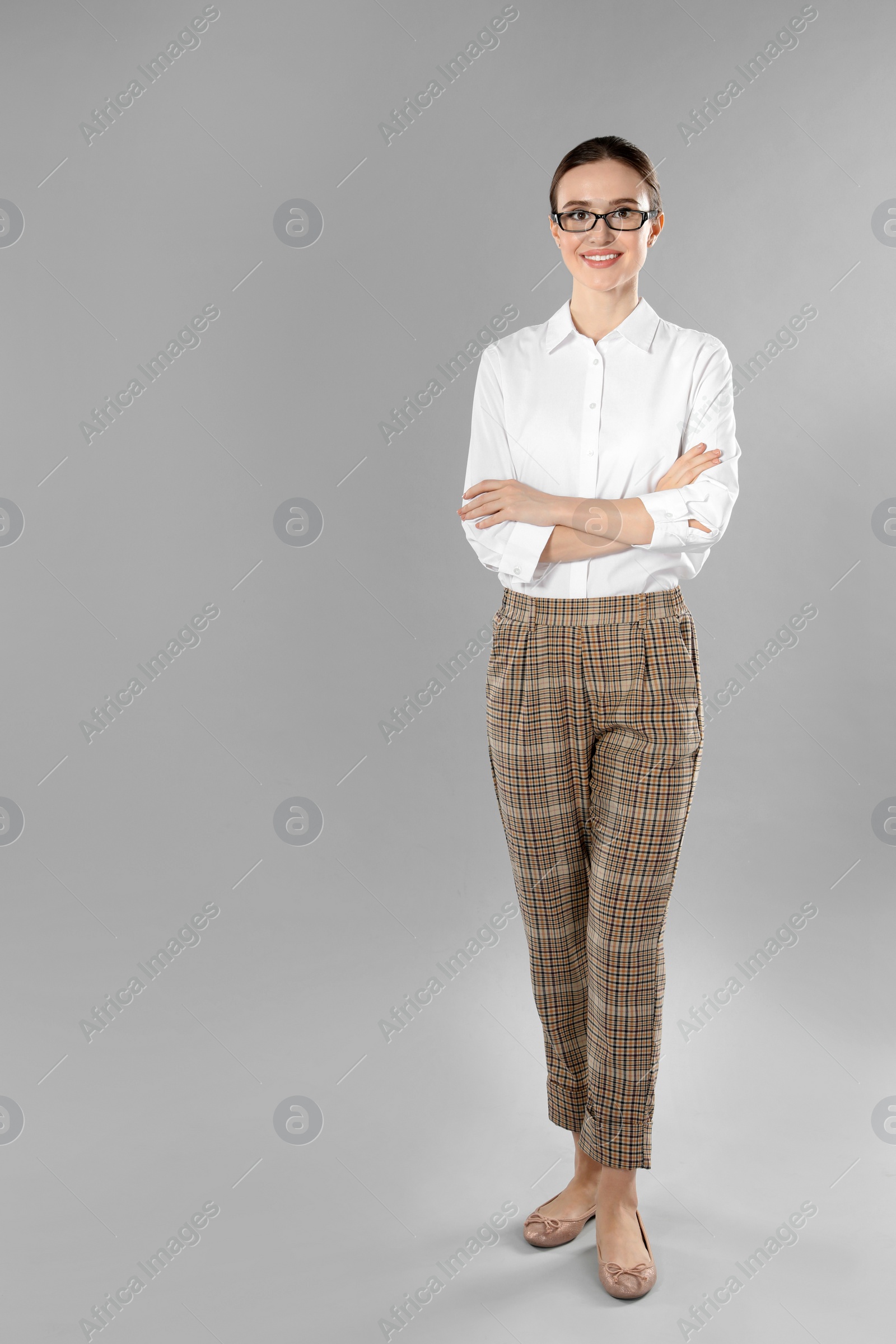 Photo of Full length portrait of young female teacher on grey background