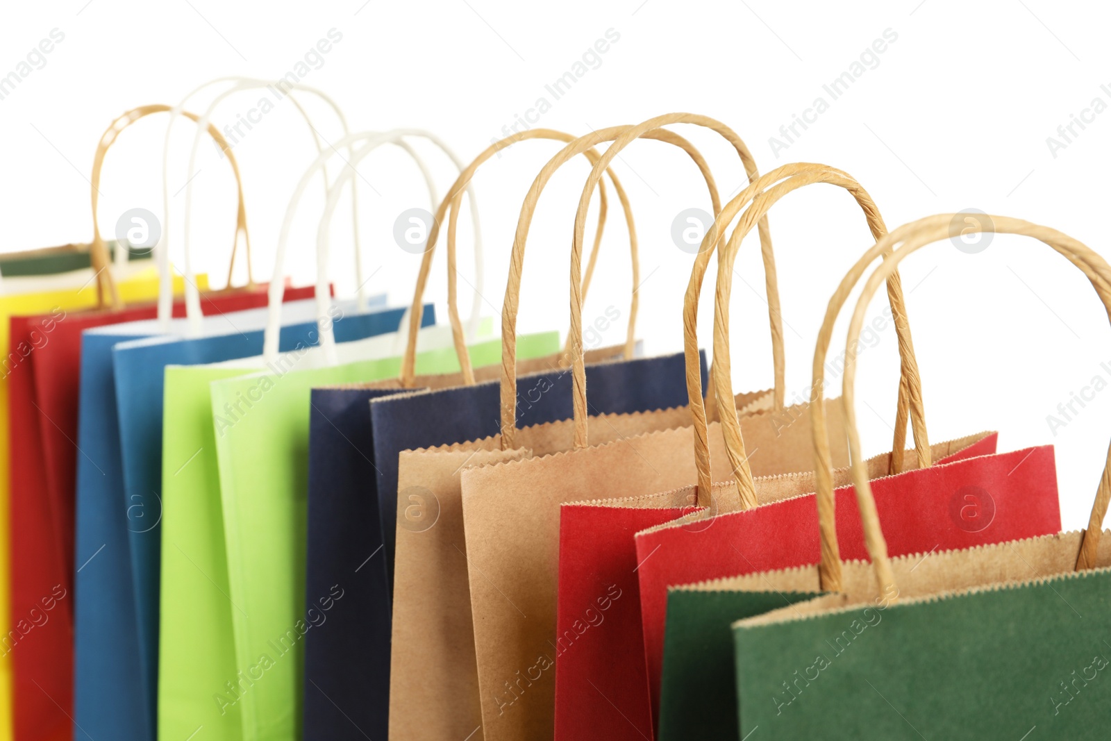 Photo of Colorful paper shopping bags on white background