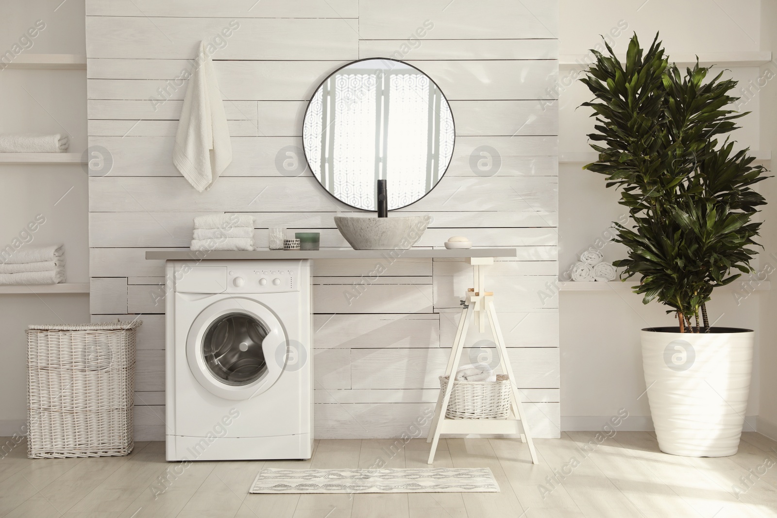 Photo of Stylish bathroom interior with modern washing machine