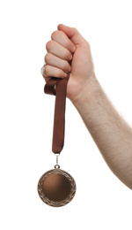 Man holding silver medal on white background, closeup. Space for design