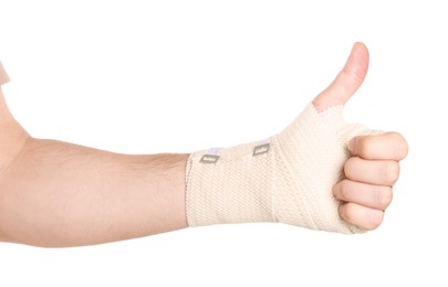 Photo of Man with hand wrapped in medical bandage on white background, closeup