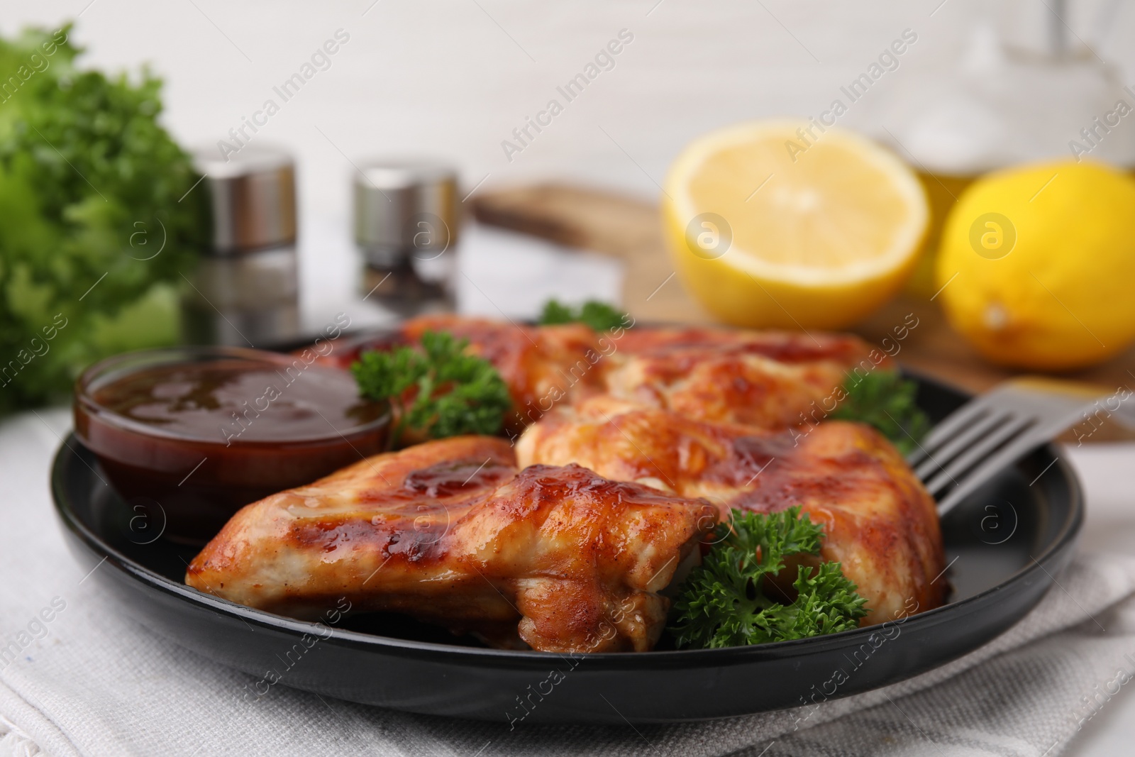 Photo of Fresh marinade and chicken wings on table, closeup