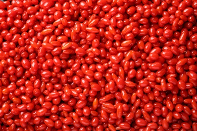 Photo of Fresh ripe goji berries as background, top view