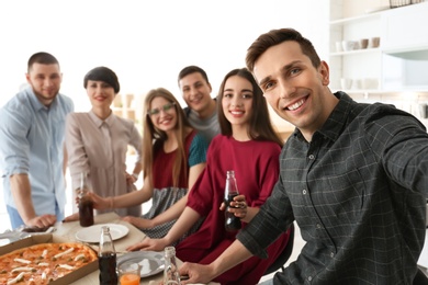 Photo of Happy friends taking selfie indoors