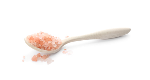 Photo of Spoon with pink himalayan salt isolated on white