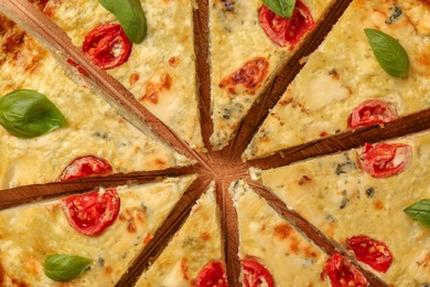 Photo of Delicious homemade cheese quiche on board, top view