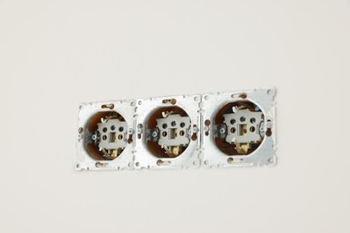 Photo of Unfinished electric power sockets on white wall