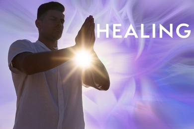 Image of Man meditating on color background. Healing concept