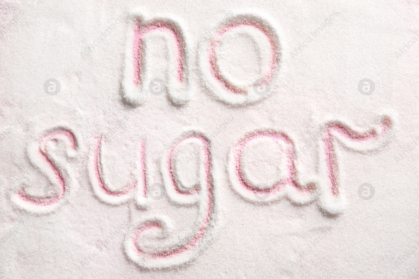 Photo of Phrase NO SUGAR written on sugar sand