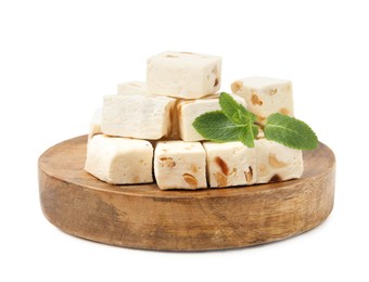 Photo of Pieces of delicious nougat and mint isolated on white