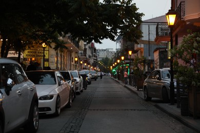 Photo of BATUMI, GEORGIA - MAY 31, 2022: Beautiful city street with buildings and parked cars in evening