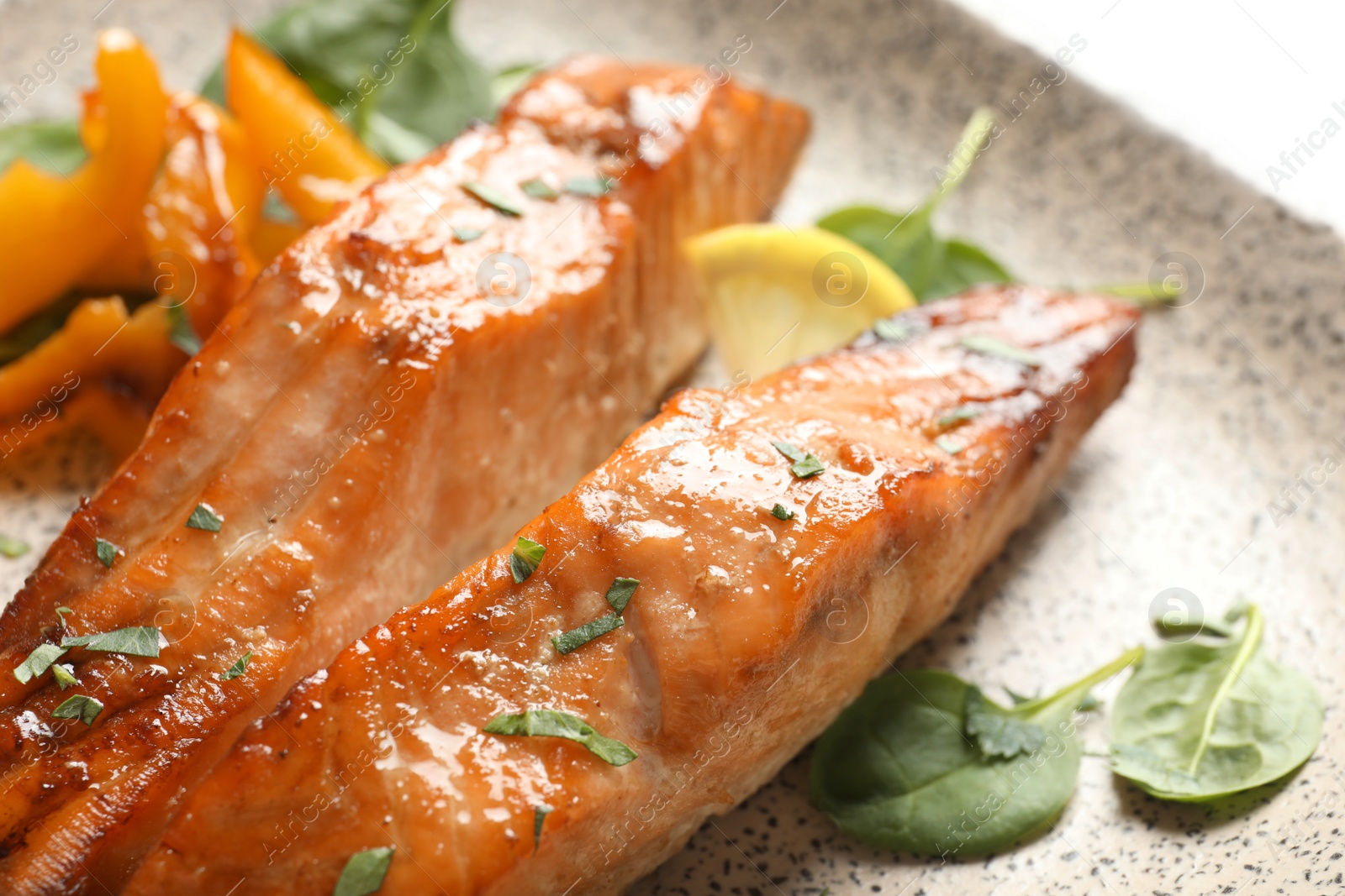 Photo of Tasty cooked salmon with lemon on plate, closeup