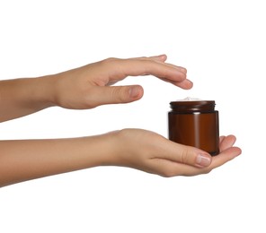 Woman taking hand cream from jar, closeup