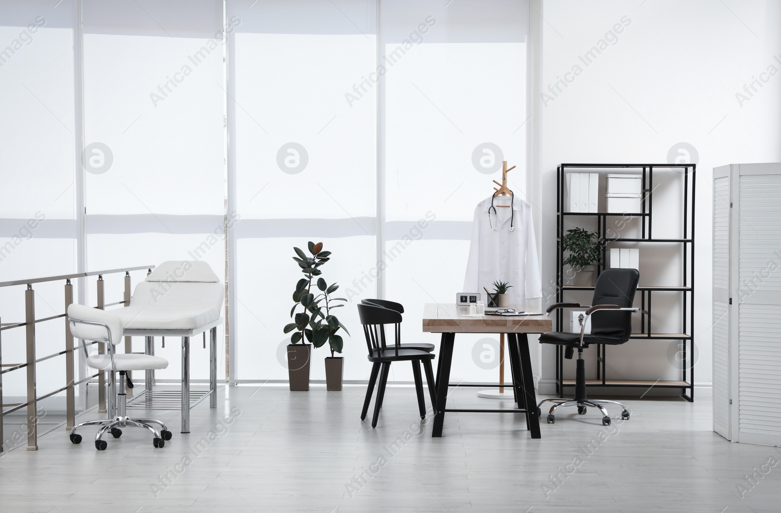 Photo of Modern medical office interior with doctor's workplace