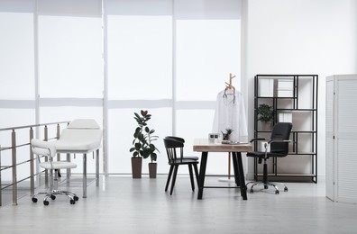 Photo of Modern medical office interior with doctor's workplace