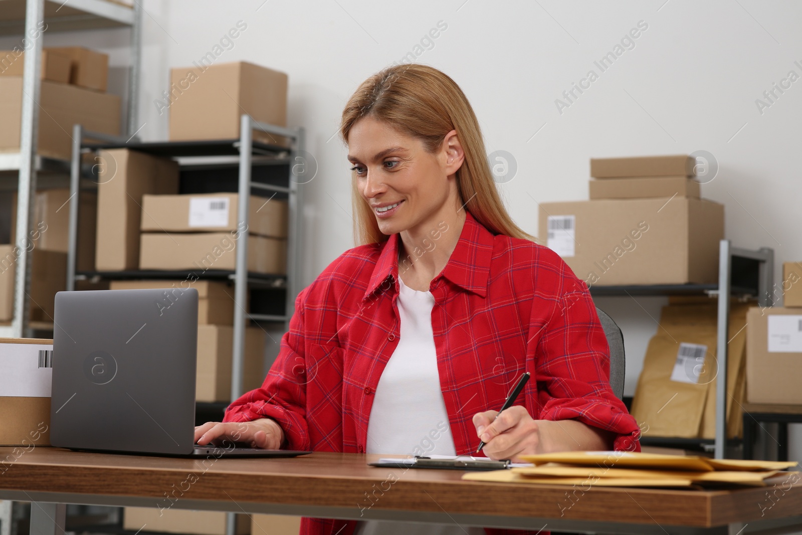 Photo of Seller with laptop working in office. Online store