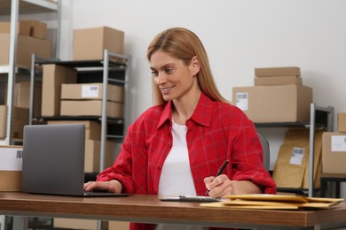 Photo of Seller with laptop working in office. Online store