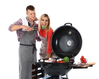 Happy couple cooking on barbecue grill, white background