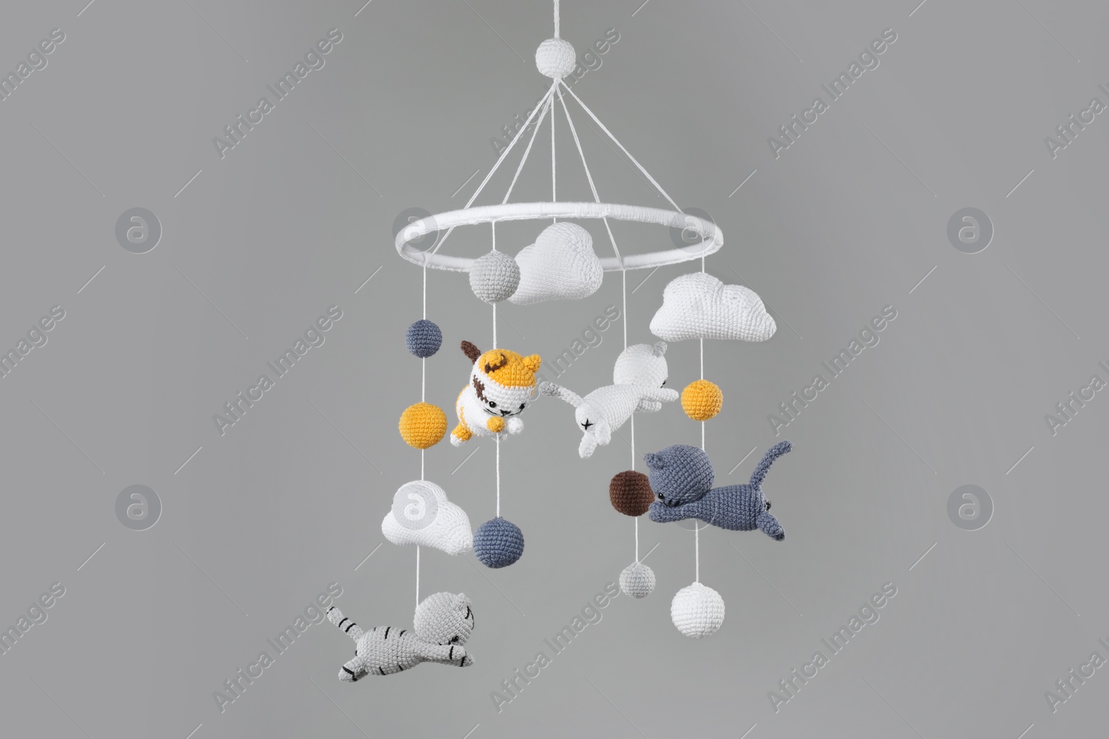 Photo of Cute baby crib mobile on grey background