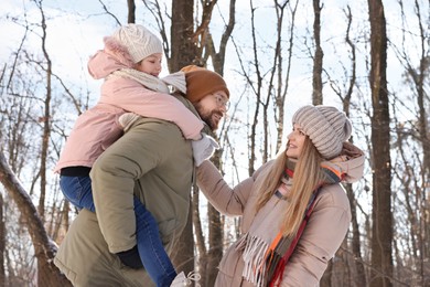 Happy family spending time together in forest