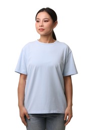 Woman wearing light blue t-shirt on white background