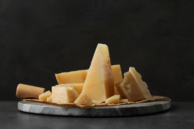 Photo of Marble board with delicious cheese on table